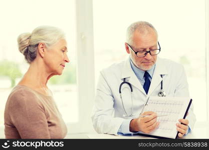 medicine, age, health care and people concept - senior woman and doctor meeting in medical office