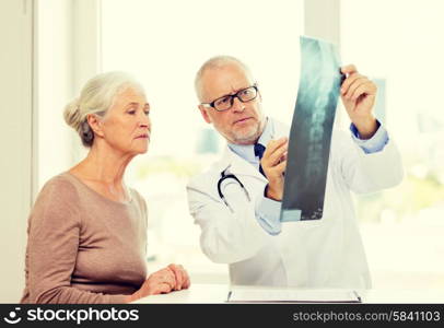 medicine, age, health care and people concept - senior woman and doctor meeting in medical office