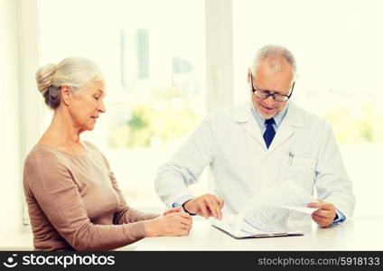 medicine, age, health care and people concept - senior woman and doctor meeting in medical office