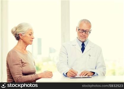 medicine, age, health care and people concept - senior woman and doctor meeting in medical office