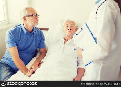 medicine, age, health care and people concept - senior woman, man and doctor with clipboard at hospital ward