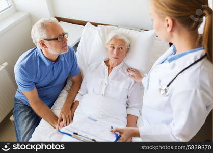 medicine, age, health care and people concept - senior woman, man and doctor with clipboard at hospital ward