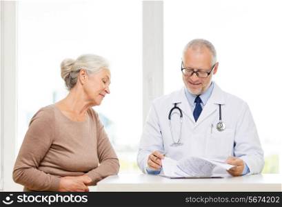 medicine, age, health care and people concept - smiling senior woman and doctor meeting in medical office