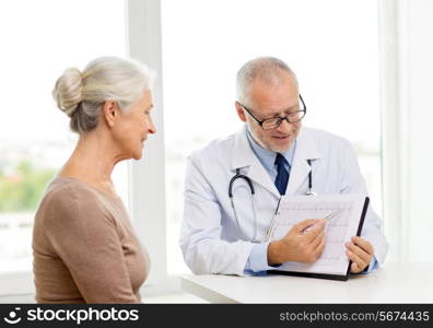 medicine, age, health care and people concept - smiling senior woman and doctor meeting in medical office