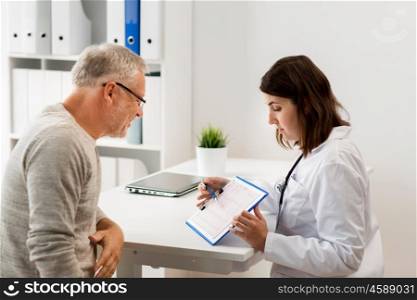 medicine, age, health care, cardiology and people concept - senior man and doctor with cardiogram on clipboard meeting in medical office at hospital