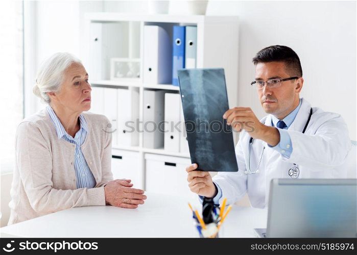 medicine, age, healthcare and people concept - senior woman and doctor with x-ray at hospital. senior woman and doctor with x-ray at hospital