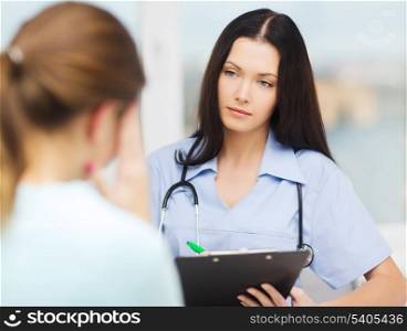medicine and health concept - female doctor or nurse with concerned patient