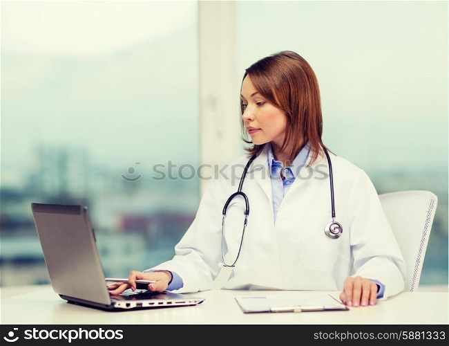 medicine and healthcare concept - busy doctor with laptop computer