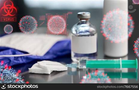 medicine and healthcare concept - close up of syringe, drug, wound wipes, gloves and mask on table over coronavirus virions. syringe with medicine over coronavirus virions