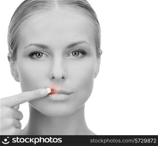 medicine, beauty, people and health concept - beautiful young woman pointing finger to her lips over white background