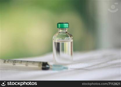Medicine bottles glass and syringe injection needle on the table / Medication drug bottle equipment medical tool for nurse or doctor