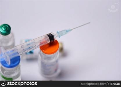 Medicine bottles glass and syringe injection needle on white background / Medication drug bottle equipment medical tool for nurse or doctor