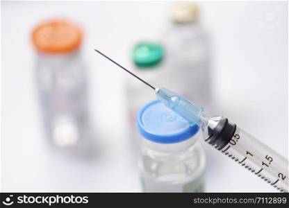 Medicine bottles glass and syringe injection needle on white background / Medication drug bottle equipment medical tool for nurse or doctor