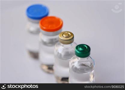 Medicine bottles glass for syringe injection needle on blue background / Medication drug bottle equipment medical tool for nurse or doctor