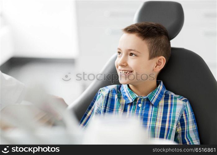 medicine, dentistry and healthcare concept - happy smiling kid patient at dental clinic. happy smiling kid patient at dental clinic. happy smiling kid patient at dental clinic