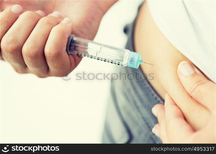 medicine, diabetes, glycemia, health care and people concept - close up of woman hands making injection with insulin pen or syringe. close up of hands making injection by insulin pen
