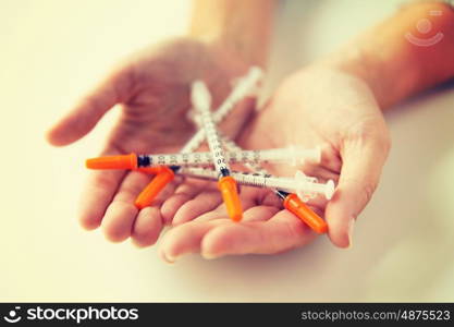 medicine, diabetes, health care and people concept - close up of woman hands holding syringes