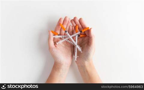 medicine, diabetes, health care and people concept - close up of woman hands holding syringes
