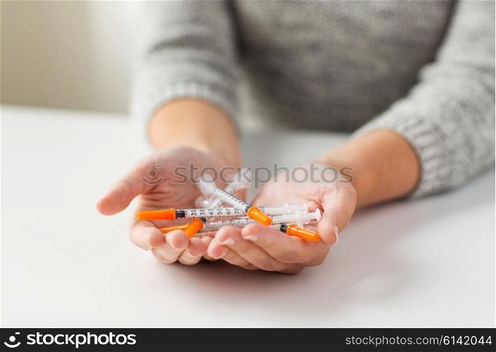 medicine, diabetes, health care and people concept - close up of woman hands holding syringes