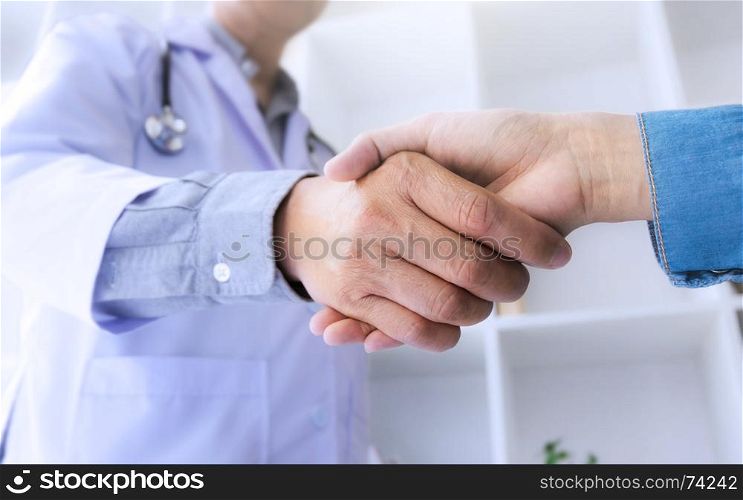 medicine doctor consultant hand shaking with patient at a hospital