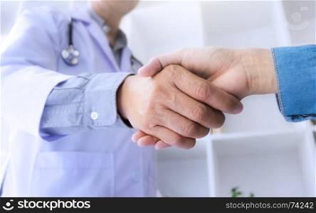medicine doctor consultant hand shaking with patient at a hospital