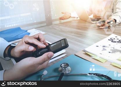 Medicine doctor hand working with modern computer and digital pro tablet with his team with digital medical diagram on wooden desk as medical concept
