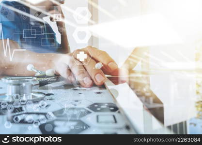 Medicine doctor hand working with modern computer with digital medical diagram on wooden desk as medical concept