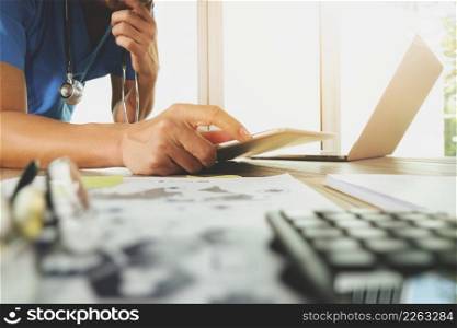 Medicine doctor hand working with modern computer with digital medical diagram on wooden desk as medical concept