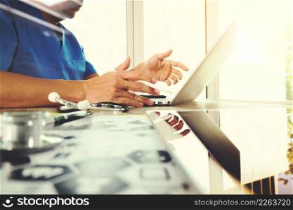Medicine doctor hand working with modern computer with digital medical diagram on wooden desk as medical concept
