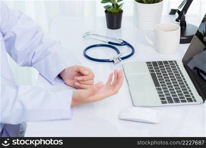 Medicine doctor’s working on desk. Closeup of Stethoscope. Hand of Asian woman physician explain to patients on table front laptop computer at the hospital office, Healthcare medic concept