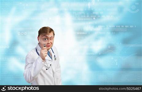 Medicine exploration. Funny young doctor with magnifier expecting something