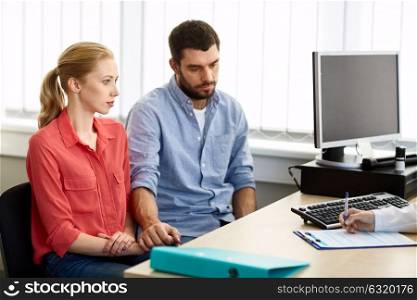 medicine, fertility and healthcare concept - couple visiting doctor at family planning clinic. couple visiting doctor at family planning clinic