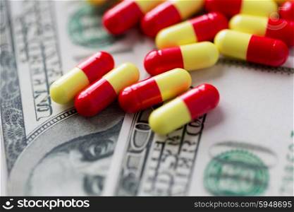 medicine, finance, health care and drug trafficking - medical pills or drugs and dollar cash money on table