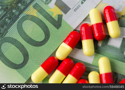 medicine, finance, health care and drug trafficking - medical pills or drugs and euro cash money on table