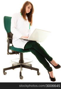 Medicine. Full length of woman doctor in lab coat working on computer laptop isolated on white. Health care.