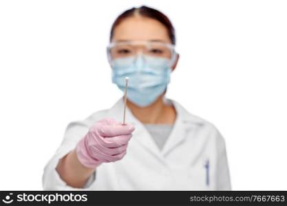 medicine, health and pandemic concept - close up of young asian female doctor or scientist in medical mask and goggles holding test cotton swab. asian female doctor in mask with test cotton swab