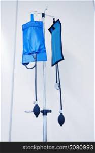medicine, health care and medical equipment concept - two sphygmomanometers or pressure infusion cuffs hanging on holder at hospital. sphygmomanometers or infusion cuffs at hospital