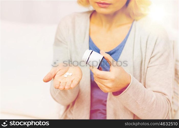 medicine, health care and people concept - close up of middle aged woman with medicine at home