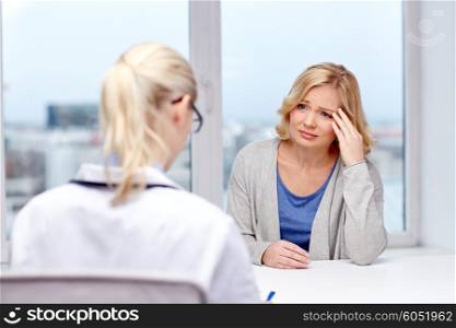 medicine, health care and people concept - doctor with clipboard and young woman patient meeting at hospital