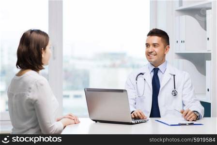 medicine, health care and people concept - smiling doctor with laptop computer and young woman meeting at hospital