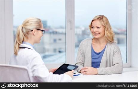 medicine, health care and people concept - smiling doctor with tablet pc computer and woman meeting at hospital