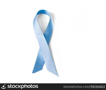 medicine, health care and symbolics concept - close up of blue prostate cancer awareness ribbon