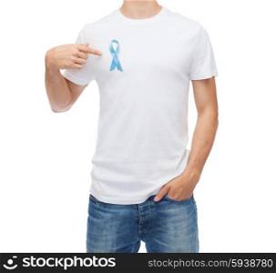 medicine, health care, gesture and people concept - man in t-shirt with blue prostate cancer awareness ribbon pointing finger on himself