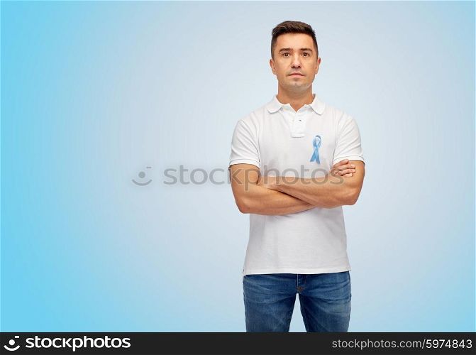 medicine, health care, gesture and people concept - middle aged latin man in t-shirt with blue prostate cancer awareness ribbon pointing finger on himself