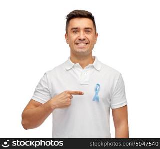 medicine, health care, gesture and people concept - smiling middle aged latin man in t-shirt with blue prostate cancer awareness ribbon pointing finger on himself