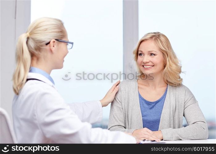 medicine, health care, meeting and people concept - smiling doctor talking to woman patient at hospital