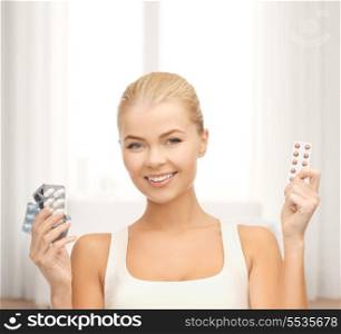 medicine, health, diet and pharmacy concept - young woman with variety of pills