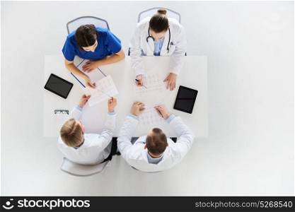 medicine, healthcare and cardiology concept - group of doctors with cardiograms, clipboard and tablet pc computers at hospital. group of doctors with cardiograms at hospital