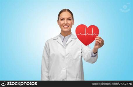 medicine, healthcare and cardiology concept - smiling female doctor with cardiogram on red heart over blue background. smiling female doctor with cardiogram on red heart