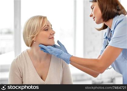medicine, healthcare and medical exam concept - doctor or nurse checking patient&rsquo;s tonsils at hospital. doctor checking patient&rsquo;s tonsils at hospital